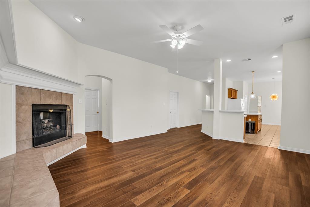 1610 Mapleleaf Falls Drive Allen, TX 75002 - Photo 17 of 36 a view of empty room with wooden floor and fireplace