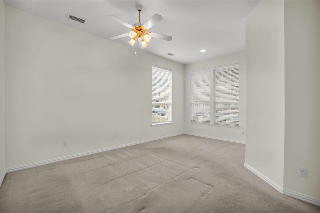 1610 Mapleleaf Falls Drive Allen, TX 75002 - Photo 18 of 36 an empty room with windows and chandelier fan