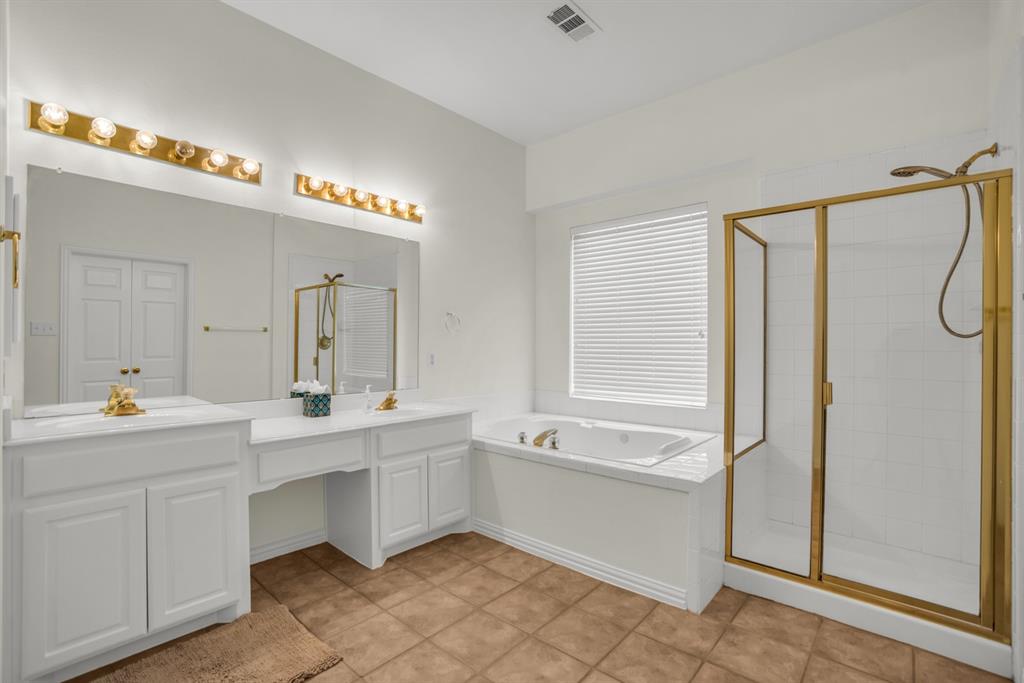 1610 Mapleleaf Falls Drive Allen, TX 75002 - Photo 21 of 36 a bathroom with a tub sink and mirror