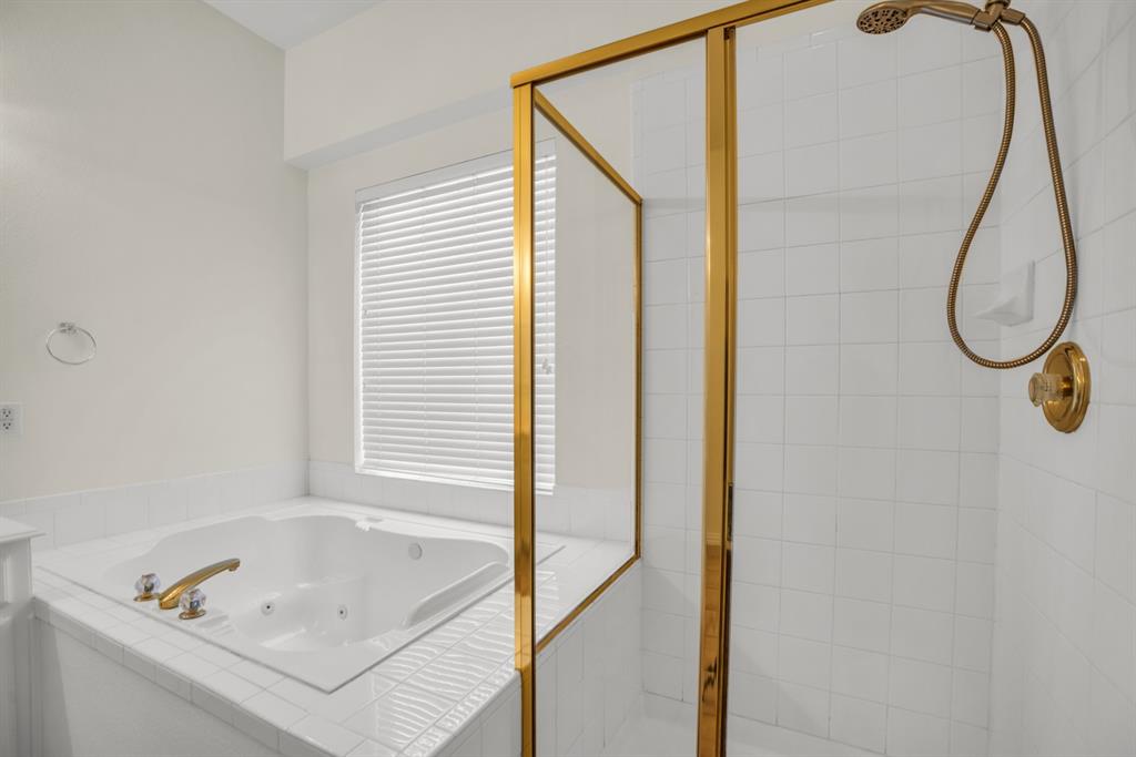1610 Mapleleaf Falls Drive Allen, TX 75002 - Photo 22 of 36 a bathroom with a tub and a window