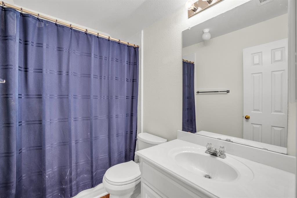 1610 Mapleleaf Falls Drive Allen, TX 75002 - Photo 33 of 36 a bathroom with a sink a toilet and shower curtain
