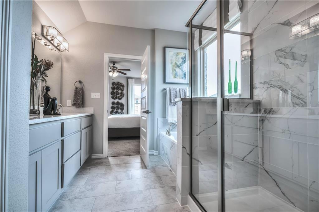 8605 Daisy Cutter Crossing Georgetown, TX 78626 - Photo 14 of 17 a bathroom with a double vanity sink a mirror and a shower