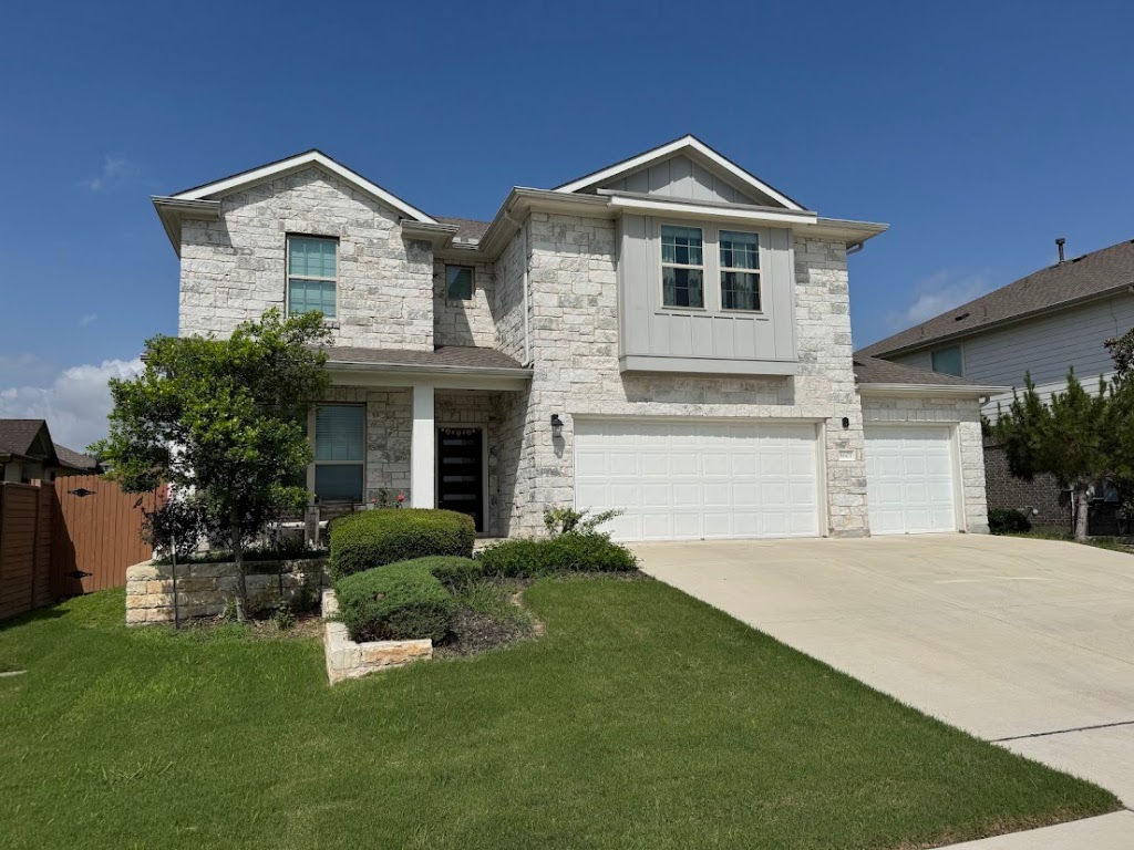 8605 Daisy Cutter Crossing Georgetown, TX 78626 - Photo 2 of 17 a front view of a house with a yard and garage