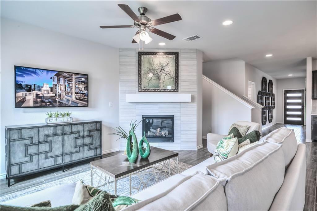 8605 Daisy Cutter Crossing Georgetown, TX 78626 - Photo 8 of 17 a living room with furniture and a fireplace