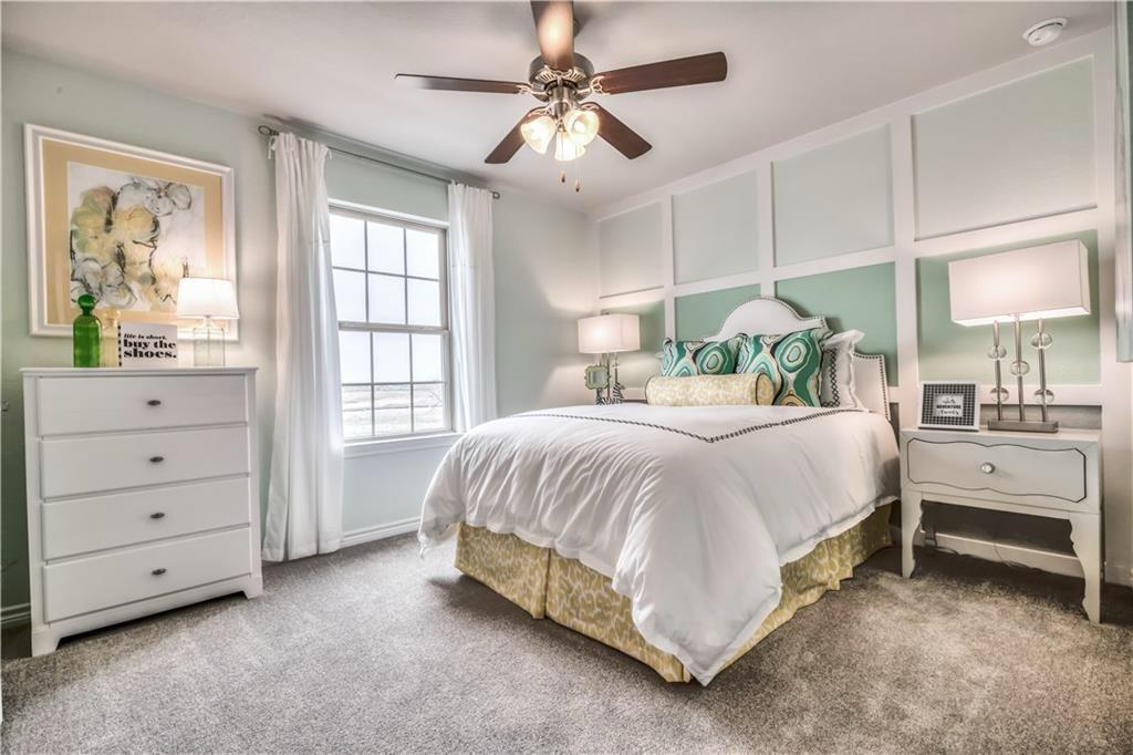 8605 Daisy Cutter Crossing Georgetown, TX 78626 - Photo 9 of 17 a spacious bedroom with a bed and a chandelier