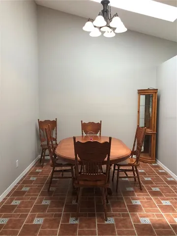 a view of a dining room with furniture and chandelier