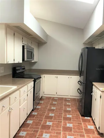 a kitchen with a cabinets and a stove top oven