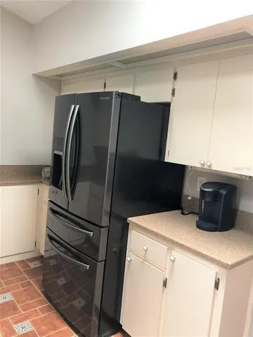 a kitchen with a refrigerator and cabinets