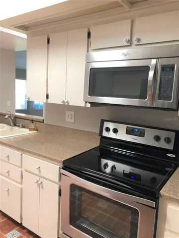 a stove top oven sitting inside of a kitchen