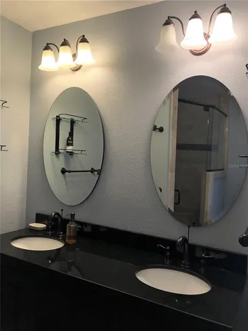 a bathroom with a double vanity sink and a mirror