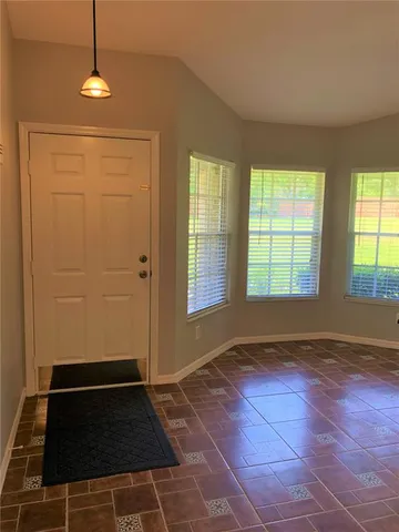 a view of an empty room with glass door