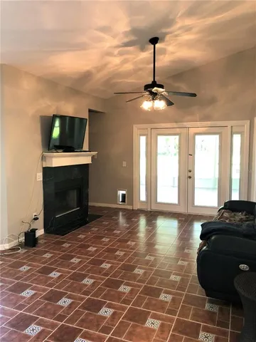 a living room with a flat screen tv and a fireplace