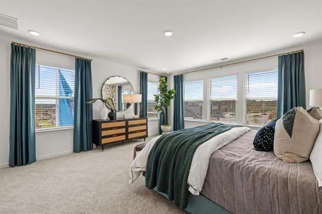 a bed room with a bed and a large window