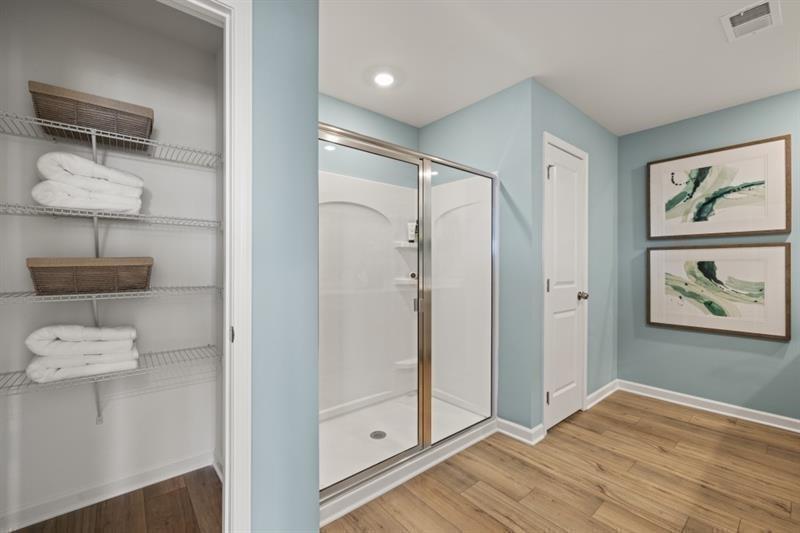 2752 Lou Lou Lane Buford, GA 30519 - Photo 16 of 25 a view of a hallway with wooden floor and cabinet