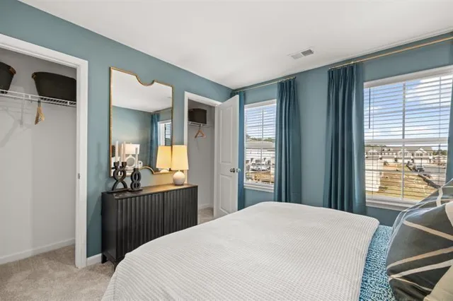 a bedroom with a bed and a large window