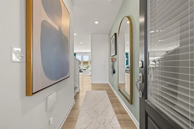 a view of a hallway with wooden floor