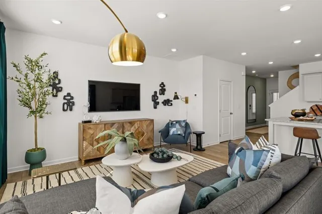 a living room with furniture and a potted plant