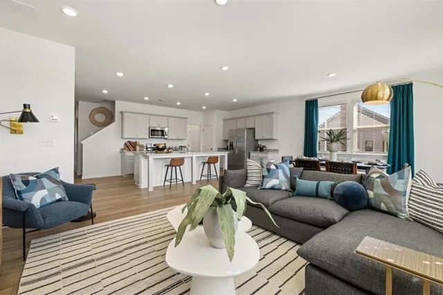 a living room with furniture and wooden floor