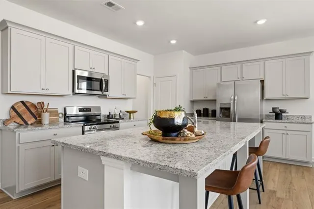 a kitchen with sink a microwave a stove and refrigerator