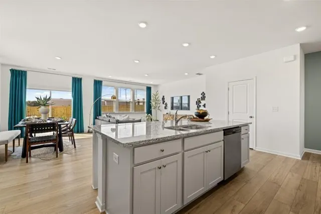 a kitchen with counter top space and living room