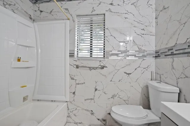 a bathroom with a toilet and a bathtub