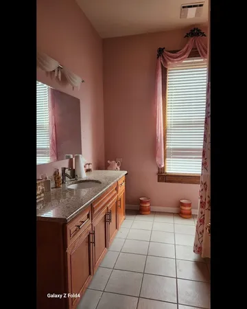 a bathroom with a sink vanity and a mirror