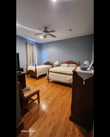 a bedroom with furniture and a chandelier