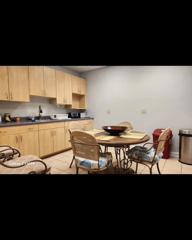 a kitchen with a sink cabinets and window