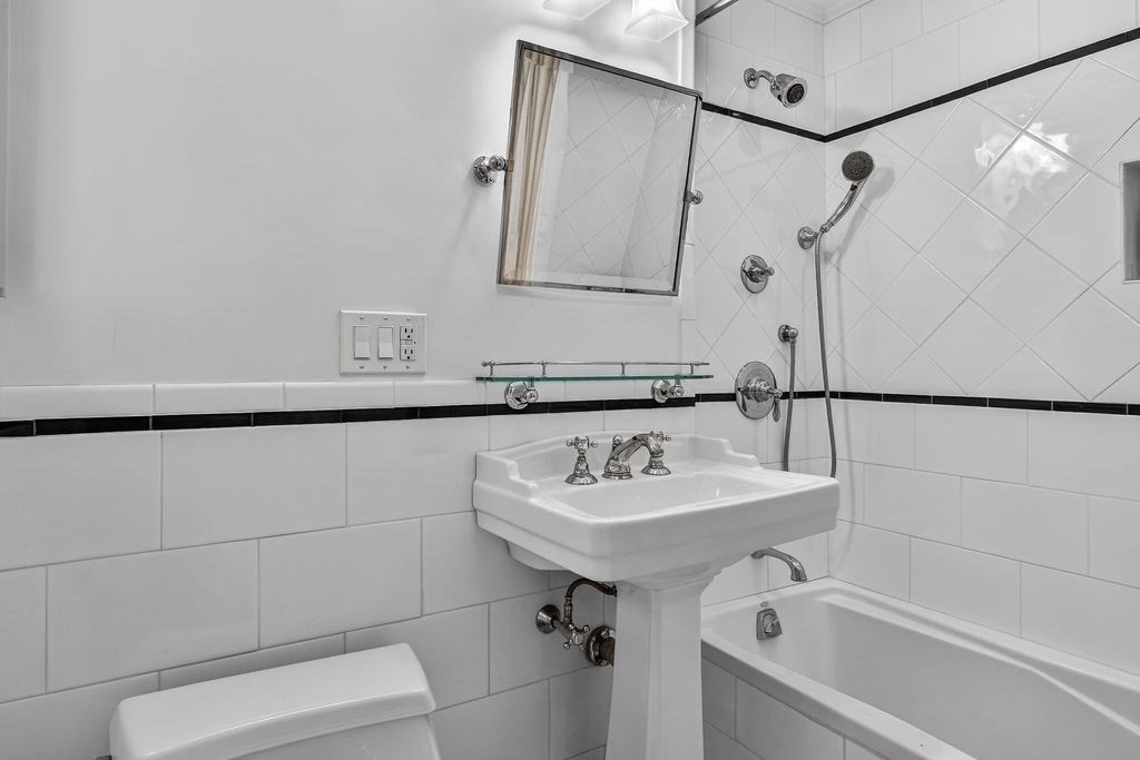 280 Beacon Street, Unit 54 Boston, MA 02116 - Photo 12 of 17 a bathroom with a sink and mirror with bathtub