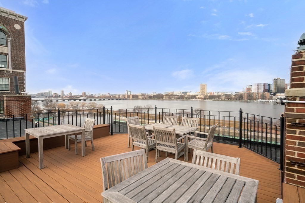 280 Beacon Street, Unit 54 Boston, MA 02116 - Photo 15 of 17 a view of a rooftop deck with chairs and wooden floor