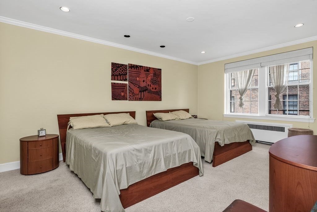 280 Beacon Street, Unit 54 Boston, MA 02116 - Photo 9 of 17 a bedroom with two beds and a window