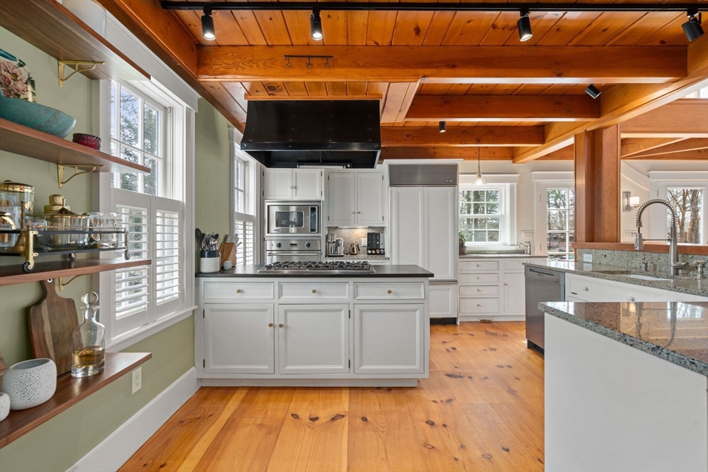5 Maple Street Sherborn, MA 01770 - Photo 15 of 34 a kitchen with stainless steel appliances granite countertop a sink and a stove