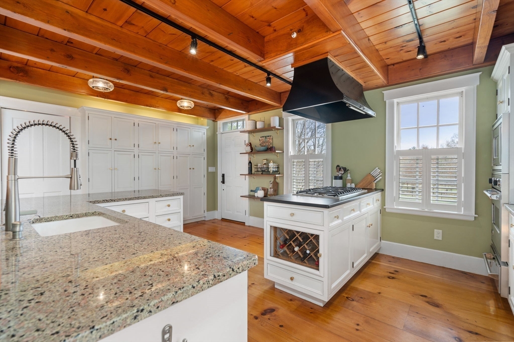 5 Maple Street Sherborn, MA 01770 - Photo 16 of 34 a kitchen with stainless steel appliances granite countertop a sink stove and cabinets