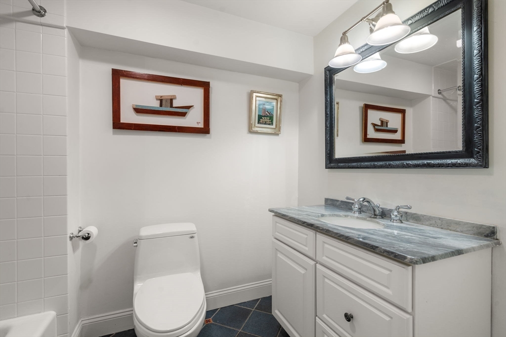 5 Maple Street Sherborn, MA 01770 - Photo 30 of 34 a bathroom with a toilet sink and mirror