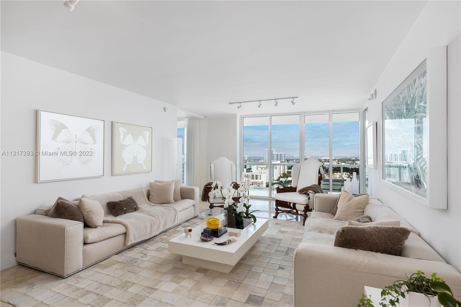 450 Alton Road, Unit 2706 Miami Beach, FL 33139 - Photo 1 of 53 a living room with furniture and a large window