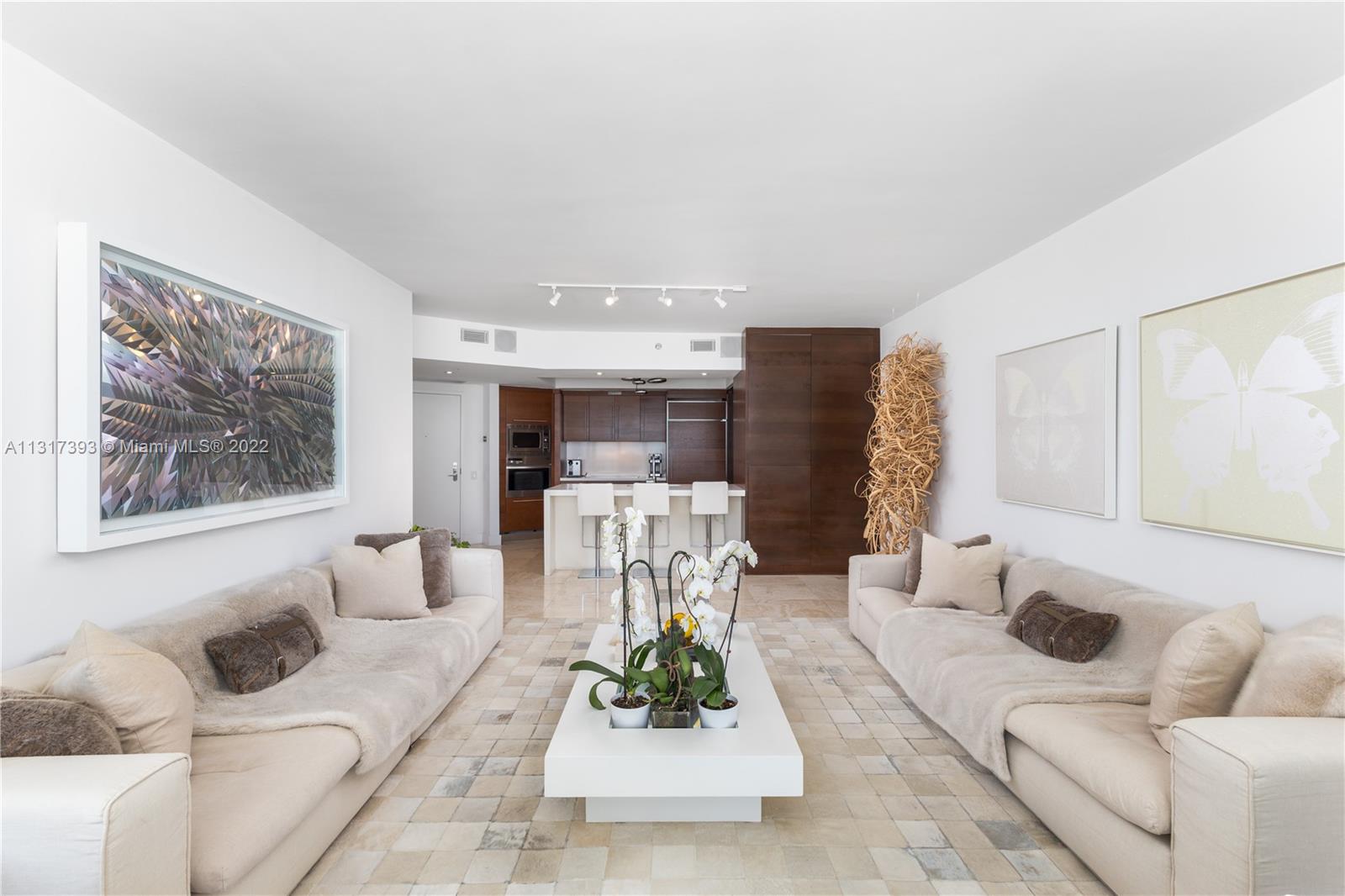450 Alton Road, Unit 2706 Miami Beach, FL 33139 - Photo 11 of 53 a living room with furniture and a chandelier