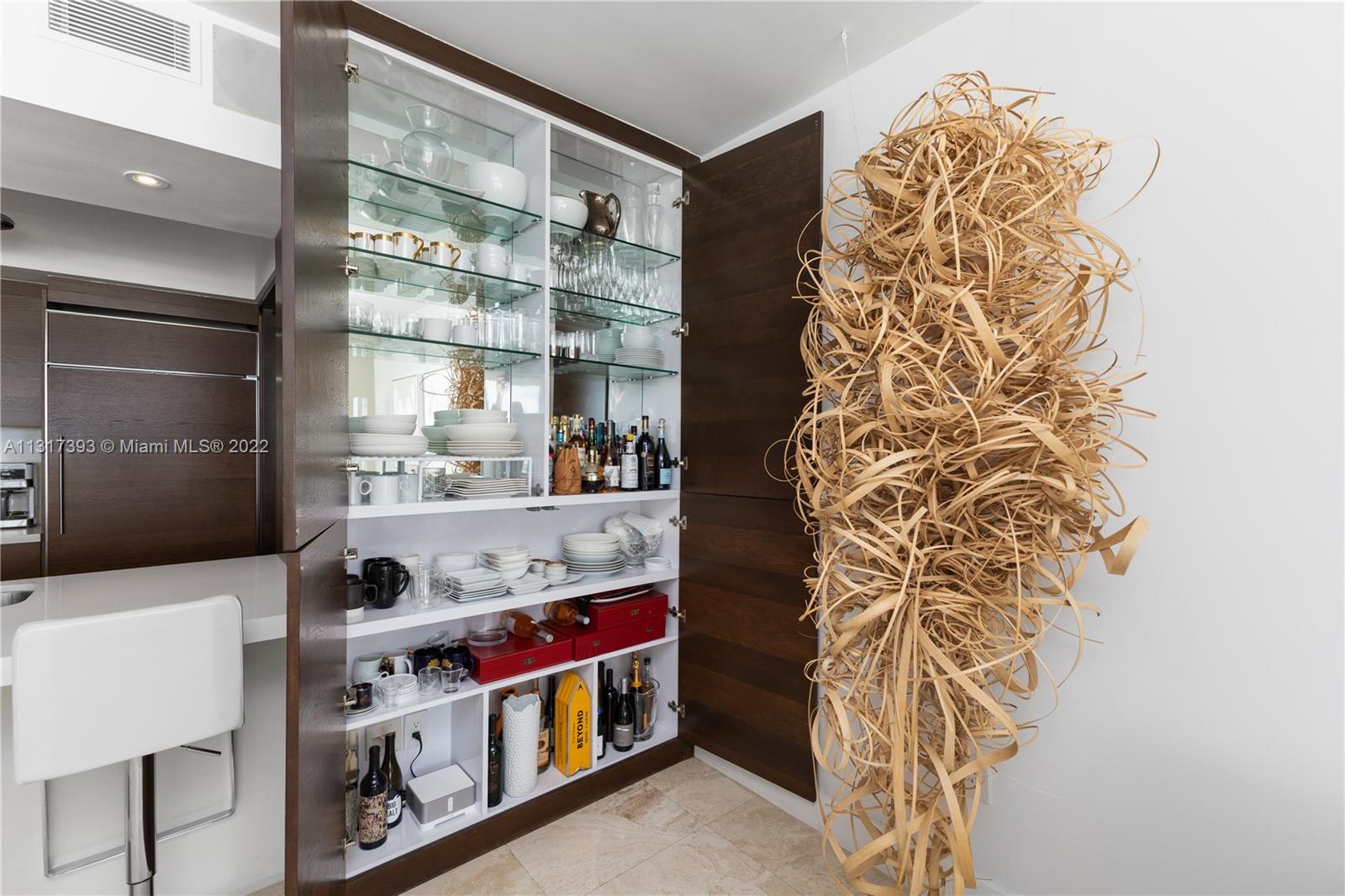 450 Alton Road, Unit 2706 Miami Beach, FL 33139 - Photo 17 of 53 a room with stainless steel appliances wooden floor and a chandelier