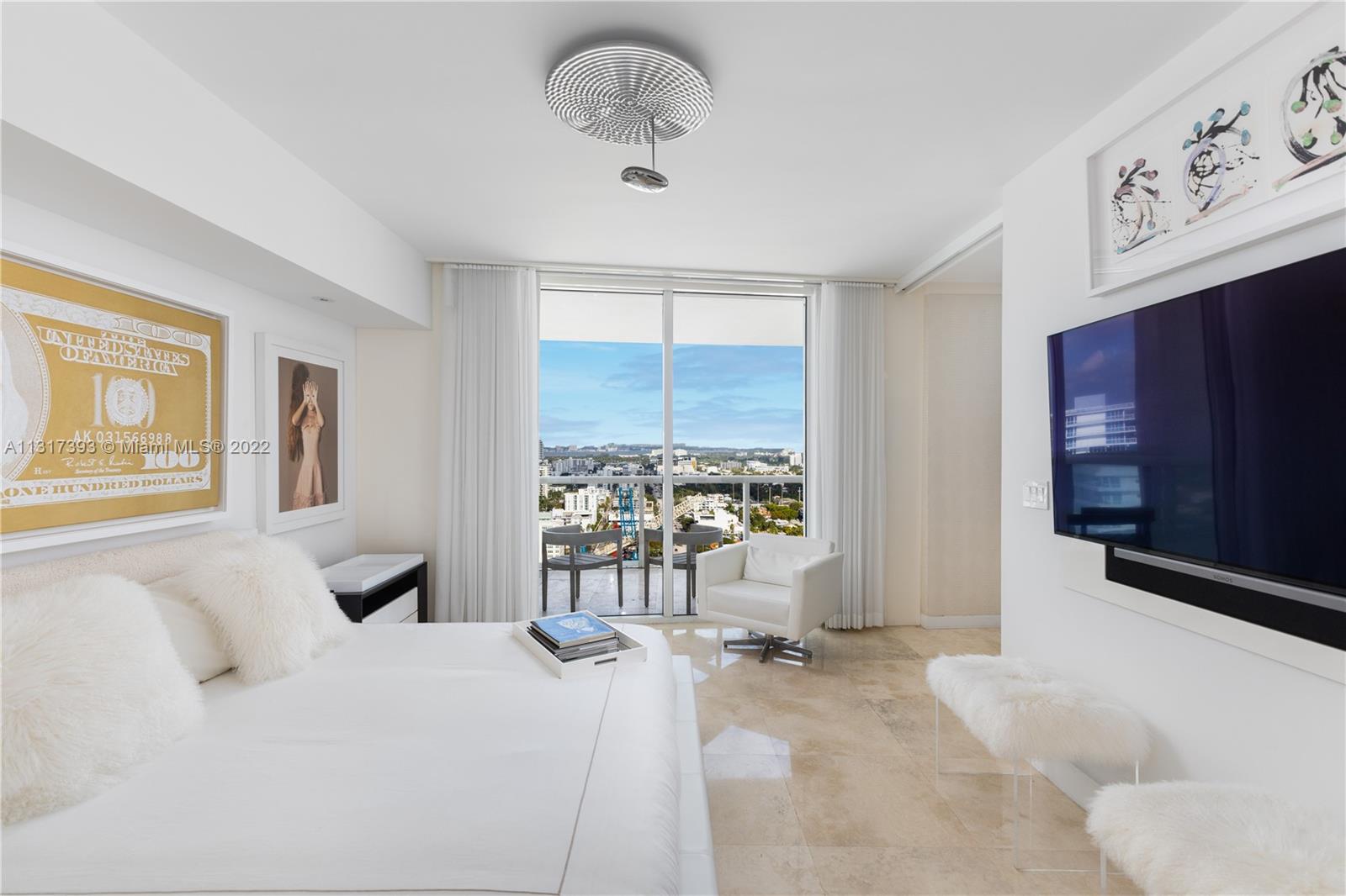 450 Alton Road, Unit 2706 Miami Beach, FL 33139 - Photo 19 of 53 a bedroom with a bed and a large window