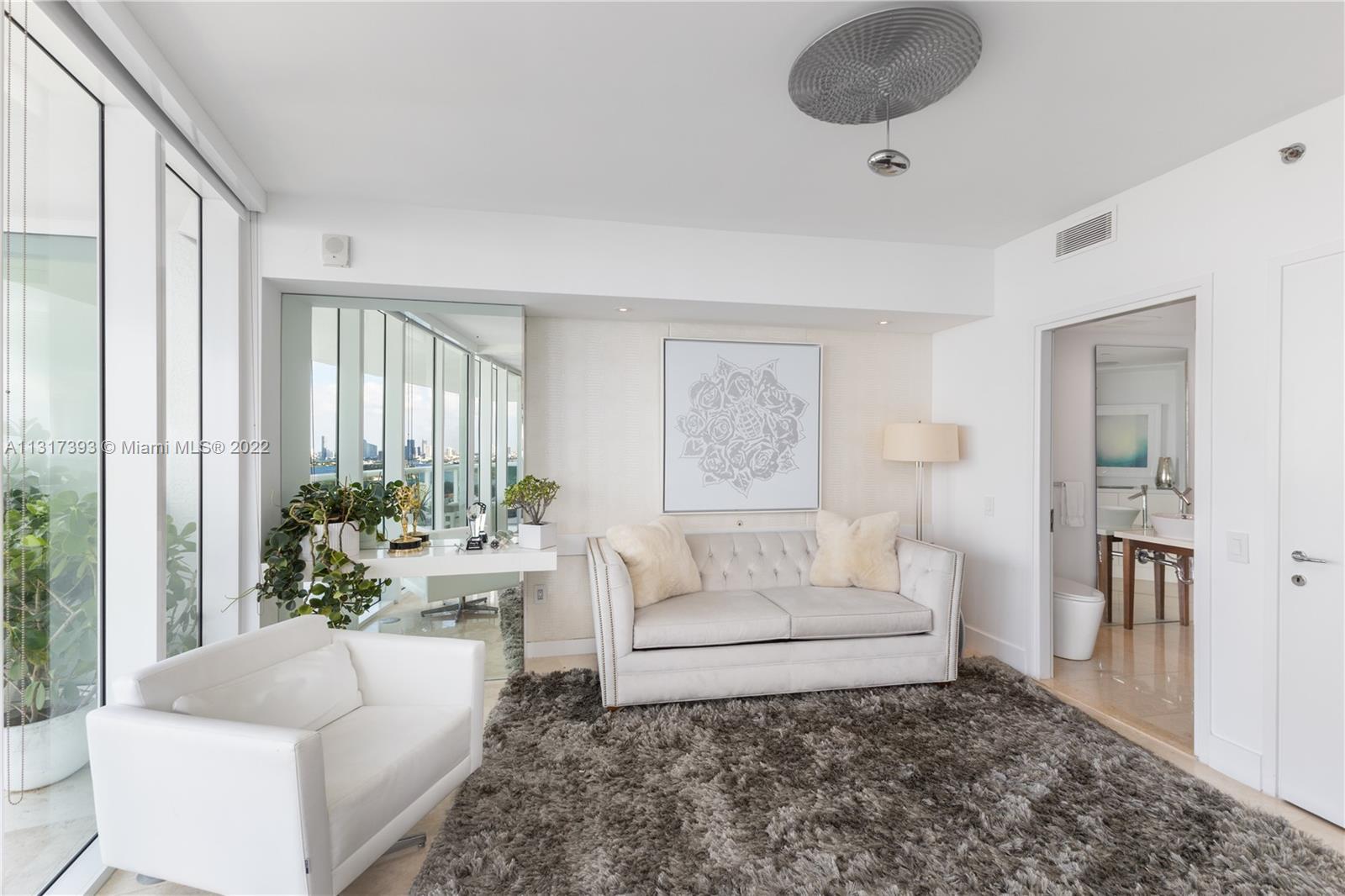 450 Alton Road, Unit 2706 Miami Beach, FL 33139 - Photo 23 of 53 a living room with furniture and a potted plant