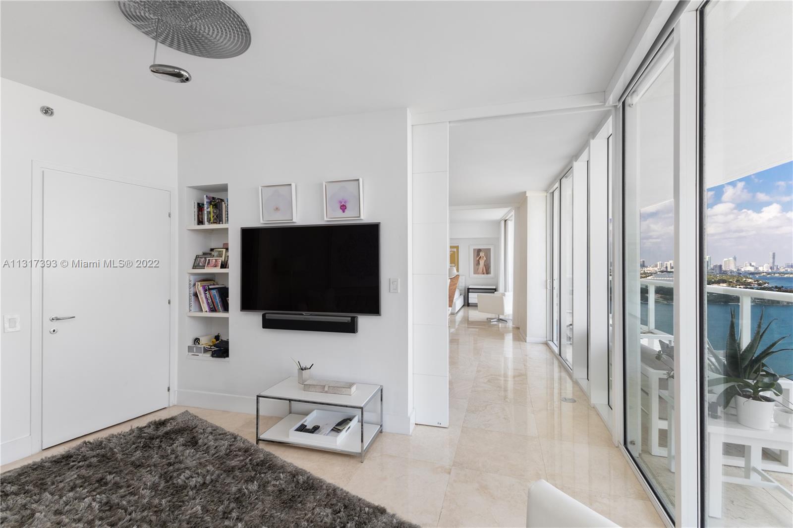 450 Alton Road, Unit 2706 Miami Beach, FL 33139 - Photo 24 of 53 a living room with furniture and a flat screen tv