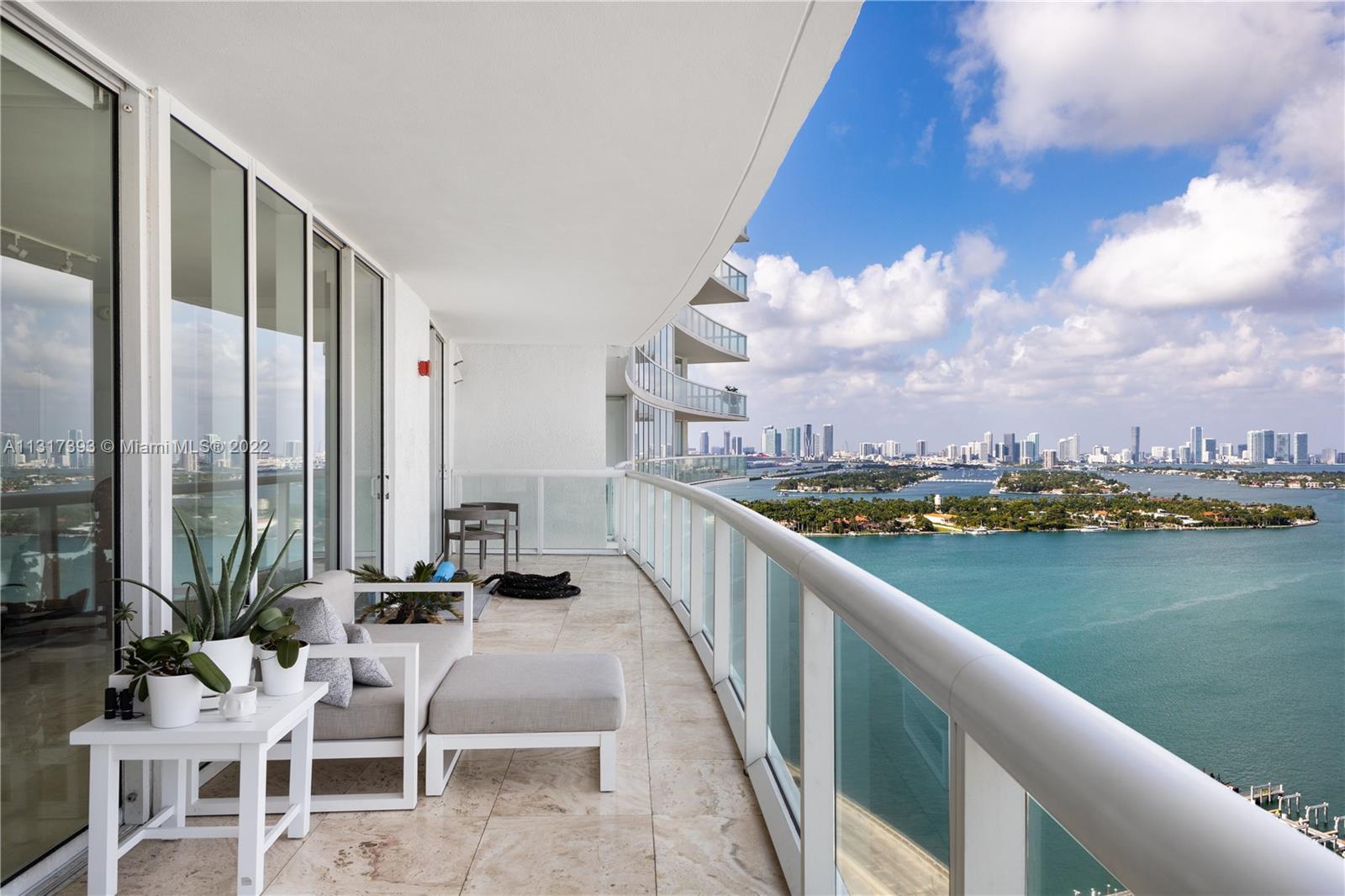 450 Alton Road, Unit 2706 Miami Beach, FL 33139 - Photo 5 of 53 a view of balcony with chairs and ocean view