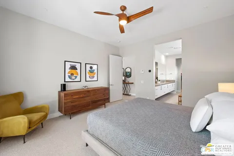 a bedroom with furniture and a ceiling fan