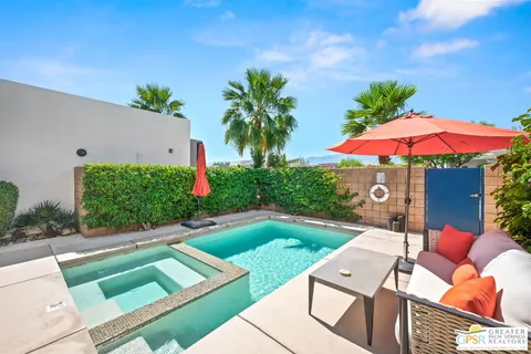 a view of a backyard with sitting area