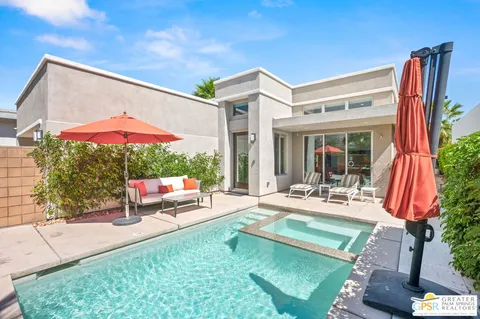 a view of a house with backyard porch and sitting area