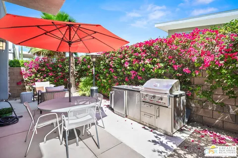 a patio with flowers and table