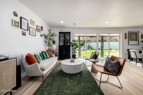 a living room with furniture a fireplace a flat screen tv and a fireplace