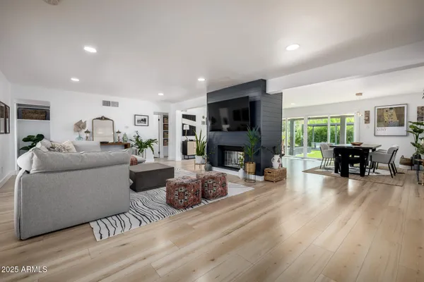 a living room with furniture and a wooden floor