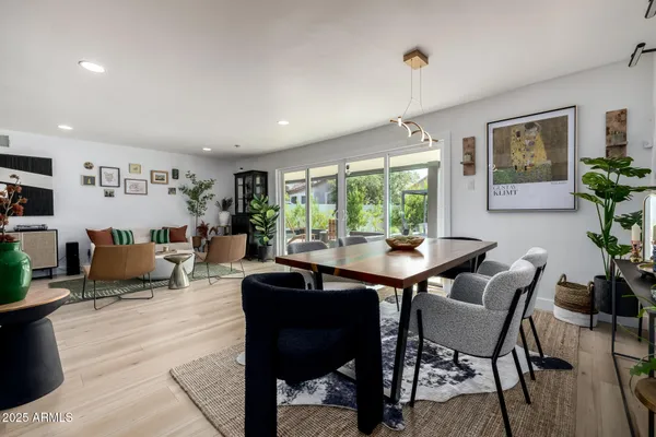 a kitchen with a table chairs stove and cabinets