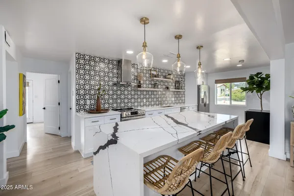 a bedroom with a bed and a refrigerator