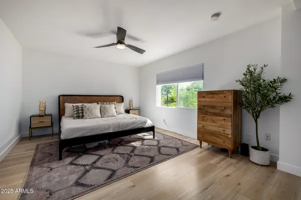 a bedroom with a bed and a chandelier